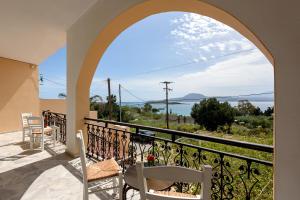 a view from a balcony with chairs and an archway at Angela Apartments new listing in Marathi