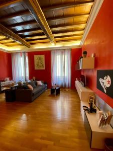 a living room with red walls and a couch at Barberini Apt close to Fontana di Trevi in Rome