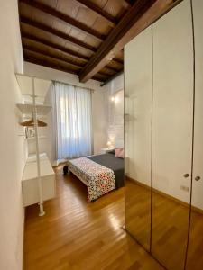 a bedroom with a bed and a glass wall at Barberini Apt close to Fontana di Trevi in Rome