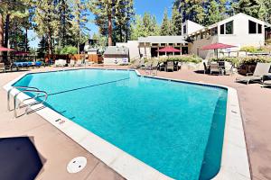 a large swimming pool with blue water in a resort at Lake Village Townhouse B in Zephyr Cove
