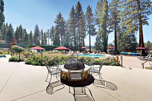 a table and chairs with a fire pit on a patio at Lake Village Townhouse B in Zephyr Cove