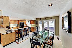 a large kitchen with a glass table and chairs at Heavenly Retreat in Stateline