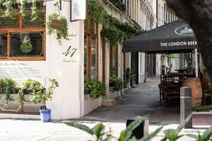 an empty street with a restaurant and an umbrella at Be London - Covent Garden Residences in London