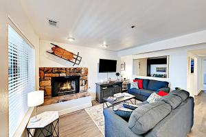 a living room with a blue couch and a fireplace at Boulder Condo N in Stateline