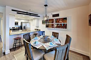 a dining room and kitchen with a table and chairs at Boulder Condo N in Stateline