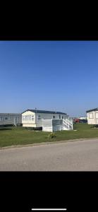 a row of mobile homes on the side of a road at Sea let’s selsey in Selsey