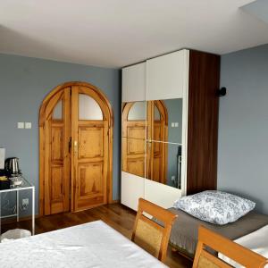 a bedroom with a bed and a dresser at Willa Różana in Wola Kalinowska