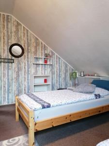 a bedroom with a wooden bed in a room at Ruhe geniessen bei Kulbes in Doberschütz
