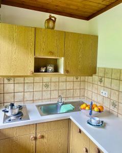 a kitchen with a sink and a bowl of fruit at Ferienwohnung 2 in Taxenbach