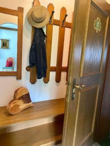a wooden shelf with a hat and a hat at Ferienwohnung 2 in Taxenbach