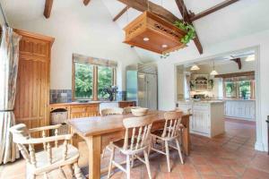 a kitchen with a wooden table and chairs at Stunning Country Farm House between Bristol & Bath in Bristol