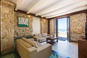 a living room with a couch and a table at Volakas Beachfront Suites in Rethymno Town