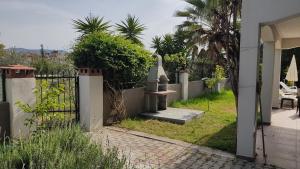 an entrance to a house with a gate and a yard at Villa Jasmin in Fethiye