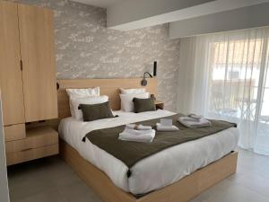 a bedroom with a large bed with towels on it at Hôtel L'Albatros in Saint-Trojan-les-Bains
