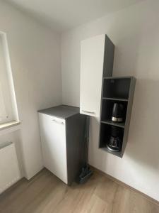 a small kitchen with a white refrigerator and a microwave at Ferienwohnung Röck in Hornberg