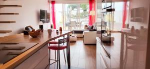 a kitchen with a counter and a living room at Marina Sunset in Le Grau-du-Roi