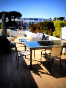 a blue table and chairs on a balcony at Marina Sunset in Le Grau-du-Roi