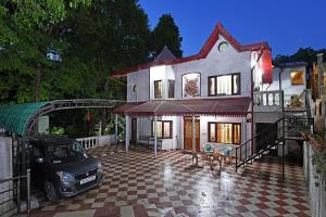 a car parked in front of a house at Dalhousie Luxury Villa in Nainital