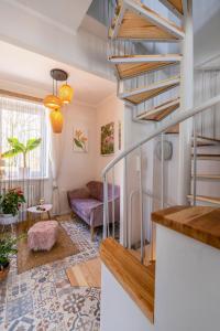 una sala de estar con una escalera de caracol en una casa en Apartament Boheme, en Lądek-Zdrój