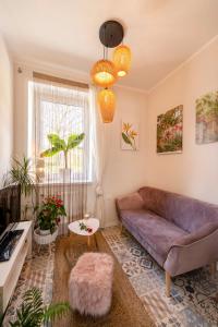 a living room with a couch and a table at Apartament Boheme in Lądek-Zdrój