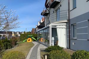 a house with a playground next to a building at U Kruszyny in Łeba