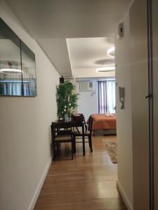 a hallway with a room with a table and a bed at Abreeza Condo T2-2820 in Davao City +19 photos