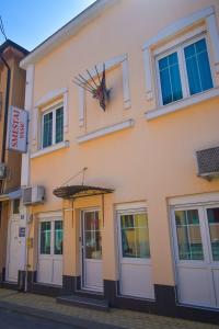 a building with a clock on the side of it at Night-Knight in Smederevo