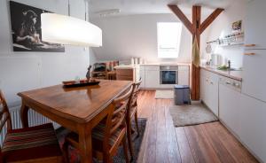 a kitchen with a wooden table and a dining room at Ferienwohnung Adolfshof 2 in Nüchel