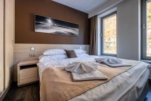 Posteľ alebo postele v izbe v ubytovaní HOTEL PECR WELL