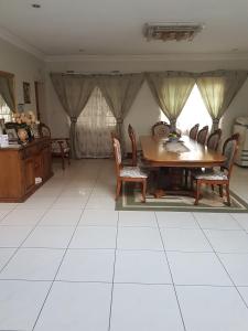 a dining room with a table and chairs at Carlcyn Homestay in Gaborone