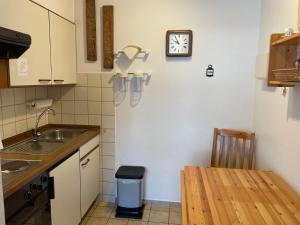 a kitchen with a sink and a clock on the wall at Apartment Cora in Winterberg