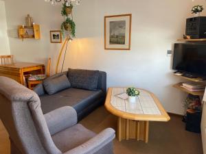 a living room with a couch and a table at Apartment Cora in Winterberg