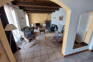 a living room with a couch and chairs at Le Vallon des âmes - Large house for 15 people in Roubion in Névache