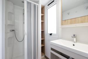 un baño con lavabo y ducha en Camping Siena Colleverde, en Siena