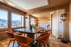 a dining room with a table and chairs at Apartment Itauba Courchevel 1850 - by EMERALD STAY in Courchevel