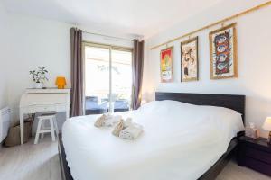 Schlafzimmer mit einem großen weißen Bett und einem Schreibtisch in der Unterkunft Ideal congress and vacation LIVE IN VILLA PARADOR in Cannes