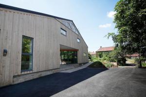 a large wooden building with a large window at The Pole Barn - Stunning, High Spec Barn Conversion in Chew Stoke