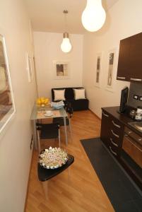 a living room with a kitchen and a table with a plate of food at Vatican Sunset Guest House in Rome +11 photos