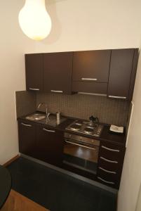 a small kitchen with a stove and a sink at Vatican Sunset Guest House in Rome