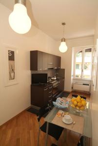 a kitchen and dining room with a table and chairs at Vatican Sunset Guest House in Rome