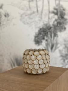 a pineapple is sitting on top of a table at Hôtel L'Albatros in Saint-Trojan-les-Bains