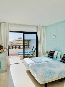 a bedroom with a large bed and a balcony at Ocean Park II in Adeje