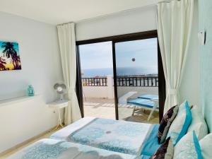a bedroom with a bed and a view of the ocean at Ocean Park II in Adeje