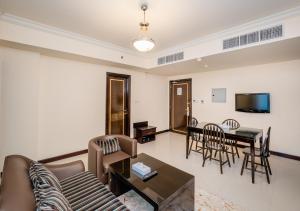 a living room with a couch and a table at City Stay Premium Hotel Apartments in Dubai