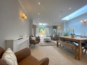 a living room with a table and chairs and a living room at St Pancras - Chichester in Chichester