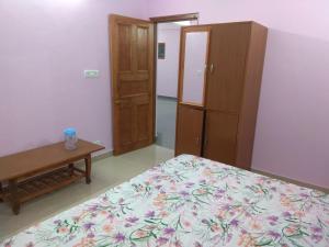 a bedroom with a bed and a cabinet and a table at A.R . Homestay in Shimla +26 photos