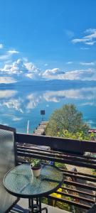 a table on a balcony with a view of the ocean at Kostoski Villa in Ohrid