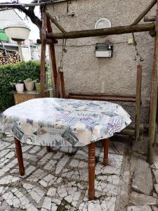 a table with a quilt on it on a patio at Емил in Velingrad