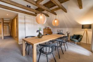a dining room with a wooden table and chairs at Goldbrunn in Oberstdorf