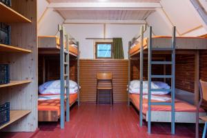 a room with three bunk beds in a house at Turisticky Raj in Hrabušice